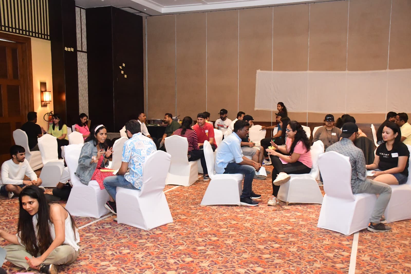 Participants seated in small groups during the Equifax Mumbai team-building event